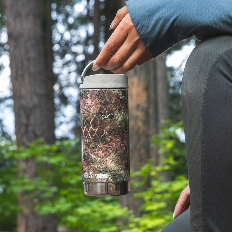 12oz-tkwide-with-twist-cap-mossy-oak-e8 12oz_tumbler_mossyoak_rainbowtrout_hand_closeup_square.jpg