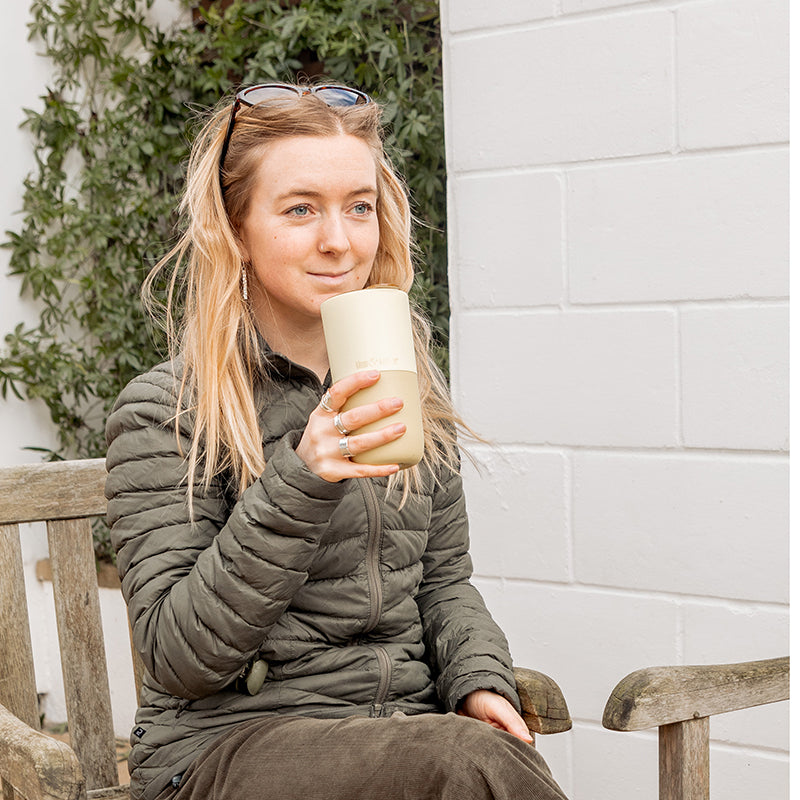 16oz-rise-tumbler-b7 16oz_rise_tumbler_wax_yellow_woman_seat_outside_square.jpg