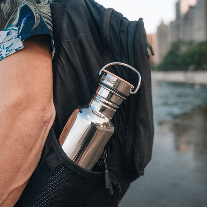 27oz-reflect-with-bamboo-cap-s8 K27SSLRF-MS-BAMBOO_reflect-bottle_backpack_lifestyle.jpg